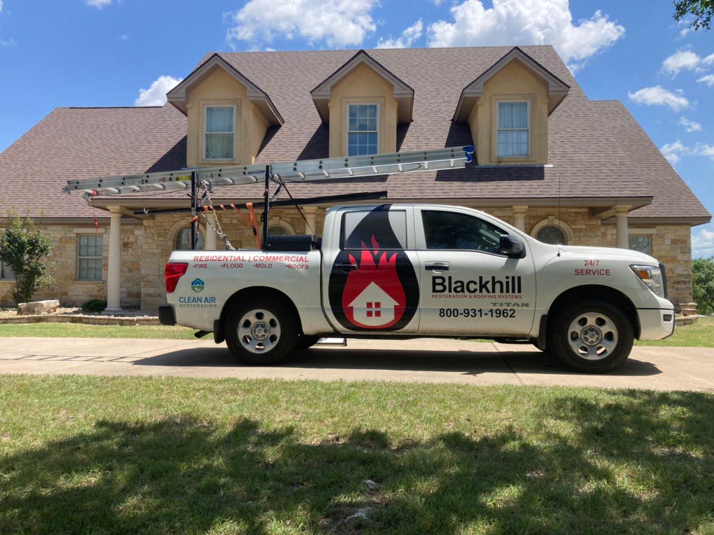 Blackhill Roofing truck in front of completed roofing project