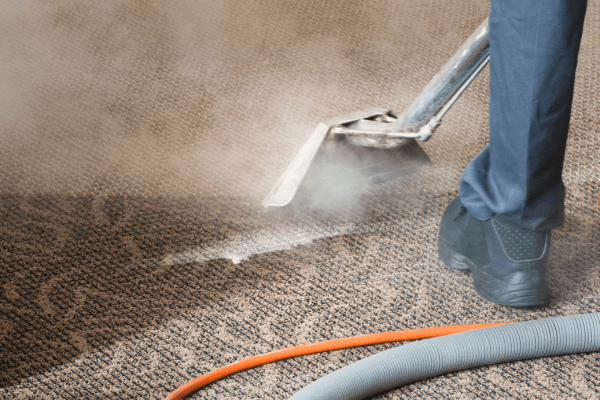 man learning how to deep clean carpet on floor